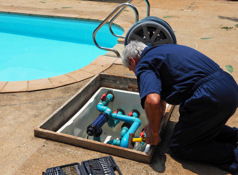 A man repairing pool tubing system